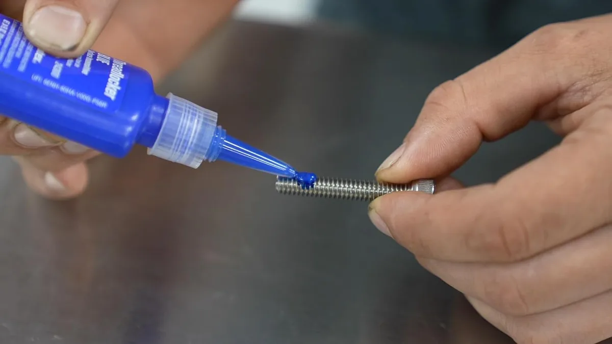 applying threadlocker to kickstand bolt