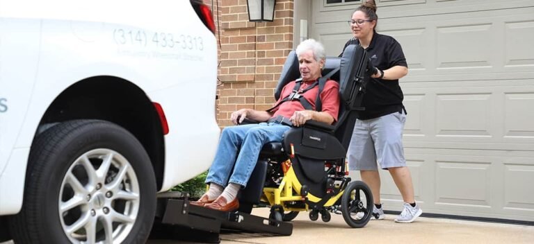 A modern transport wheelchair sits in a sunlit living room with soft natural lighting.